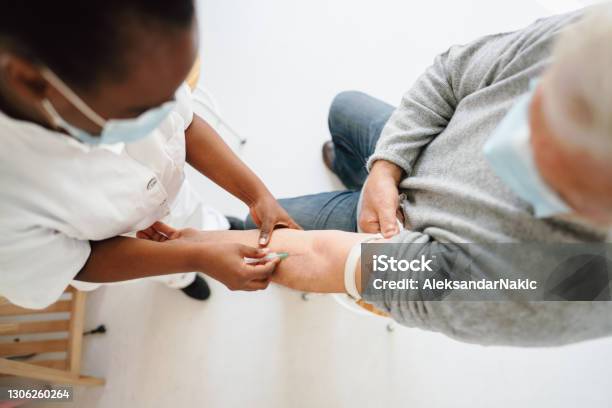 Nurse Taking A Blood Sample From A Patient Stock Photo - Download Image Now - Blood Test, Senior Adult, Nurse