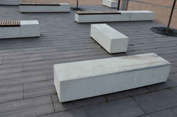 istock concrete white bench block and wave shape in the park on a dark cobbled square, clean concrete surface gray brown white pedestrian and rest area at the skate park for young people, teenagers 1306260789