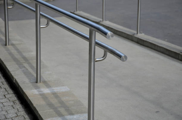 istock railing with two handrails. made of galvanized steel prisms. the lower railing is a protection against wheelchairs. ramp for the immobile in the housing estate, stainless steel 1306261095