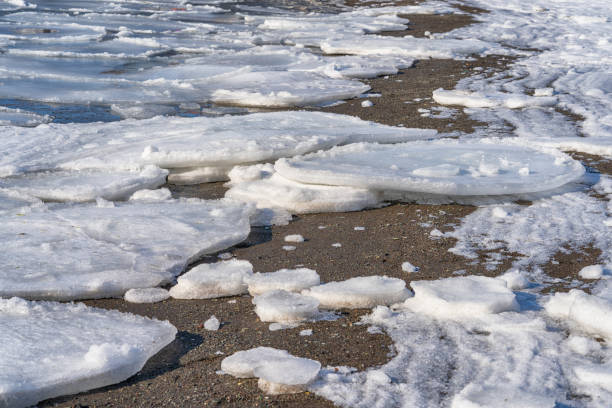 Spring. River bank with pieces of ice. stock photo