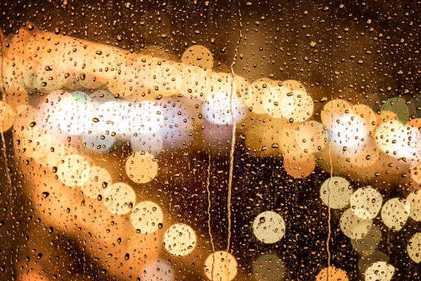 istock City night lights pattern with rain drops on window, close-up 1306262286