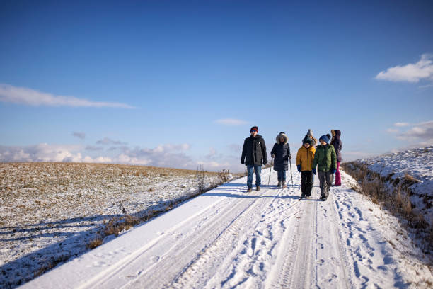 istock Multi generation family enjoying hiking in winter hills. 1306262461