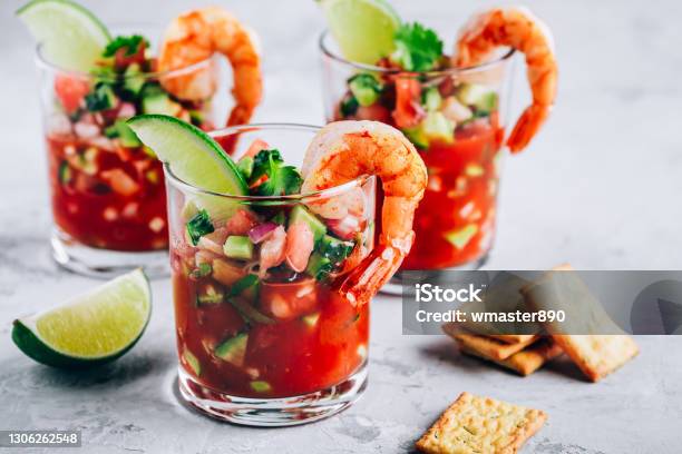 Refreshing Mexican Shrimp Cocktail With Lime In Glass On Gray Stone Background Stock Photo - Download Image Now