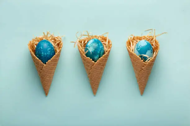 Minimalistic Easter concept with Easter eggs in waffle cones