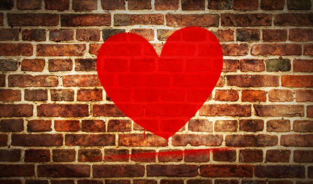 istock Heart symbol spray painted on the brick wall 1306265959
