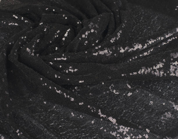 istock Abstract wavy folds of black fabric with sequins 1306267619