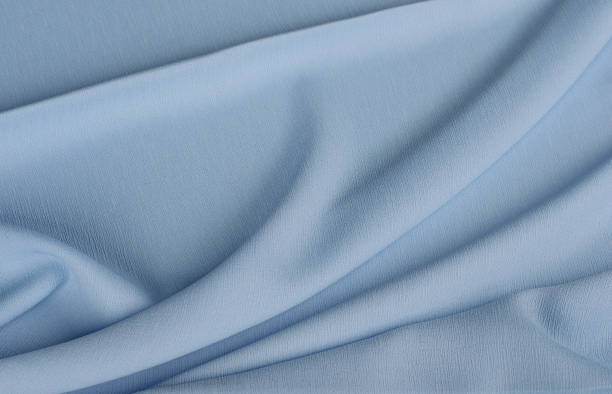 istock Abstract folds of wavy blue lightweight chiffon fabric. 1306267686