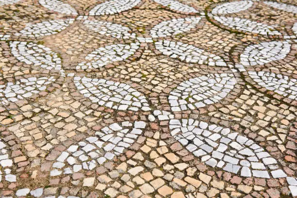 antique mosaic pavement with a pattern of tiles outdoor