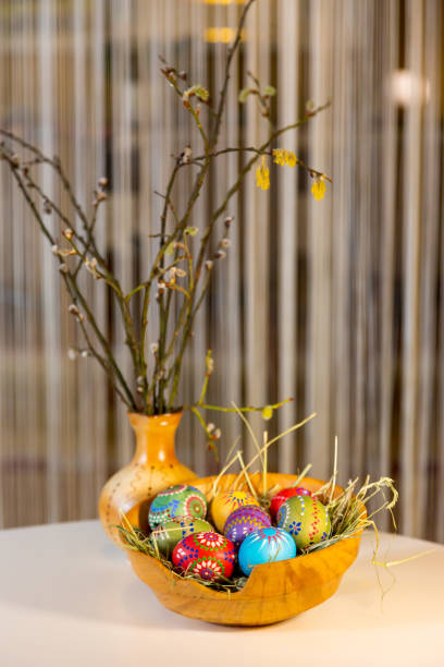 istock Easter eggs from Germany handmade with wax technique in a holz bowl with a porelan vase 1306272572