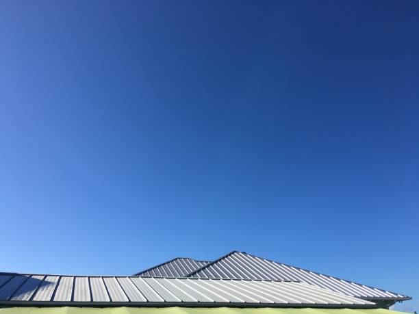 Dawn light on metal roofing with twin peaks  pointing towards clear sky. Photo taken in Cocoa Beach, Florida on iPhone 6S Plus