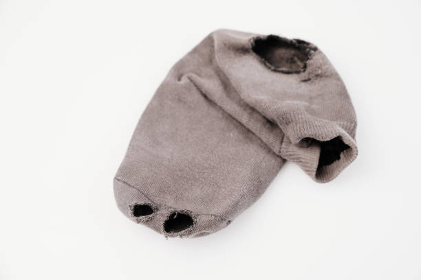 old holey sock on a white background. Poverty. lack of money to buy new clothes.