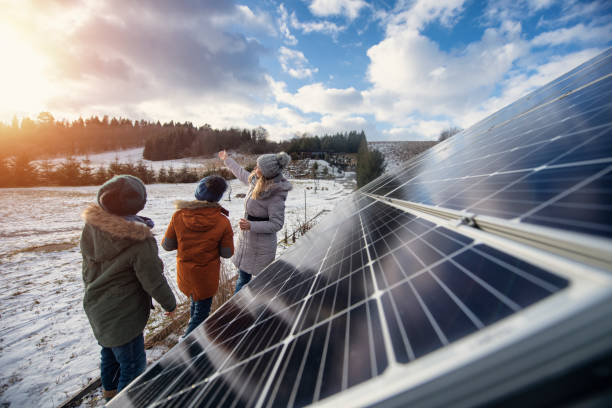 Mother explaining solar panels technology to the kids on a winter day.