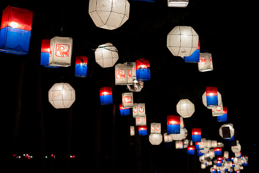 Illuminated traditional korean lamp lantern at night along a street