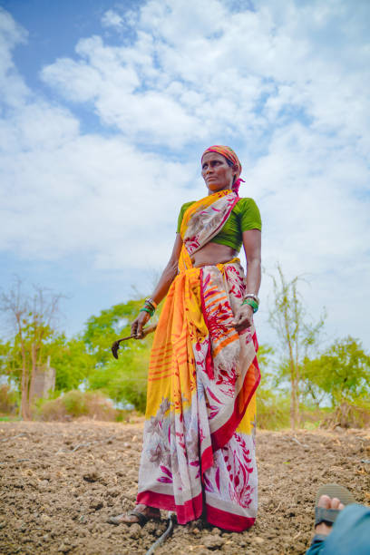 istock Indian lady working at field 1306276395