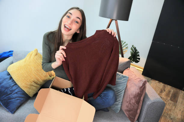 istock Young woman unboxing a package 1306276432