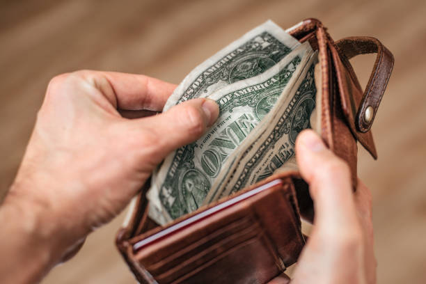 istock Hand taking US-Dollar out of a wallet 1306278572