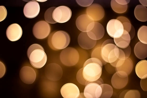 istock Bokeh. Golden defocused lights on a dark brown background. Concept for design 1306278626
