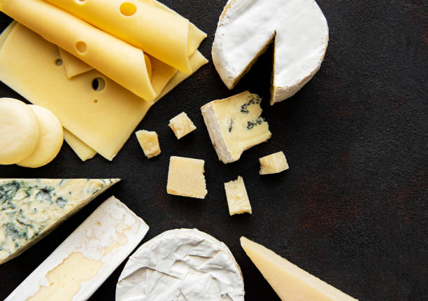 istock Various types of cheese  on a black concrete background 1306280543