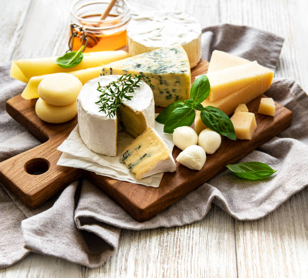 istock Various types of cheese  on a white wooden  background 1306280549