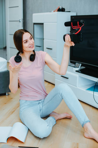 istock Enthusiastic young lady making video content at home 1306280760