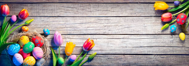 istock Easter - Decorated Eggs In Nest With Colorful Tulips On Wooden Plank 1306282333