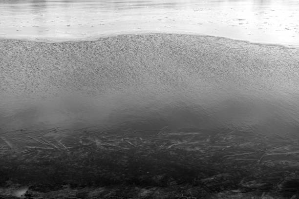 istock Partially frozen lake in black and white. 1306283196