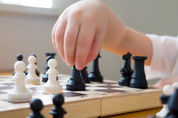 istock Close up of a kid's hand during chess game. Board games 1306285647