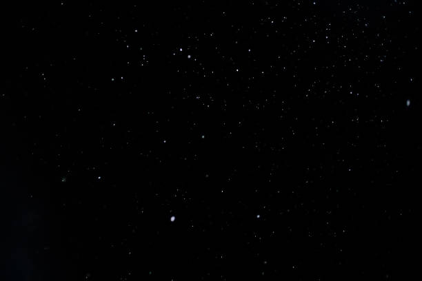 istock Snow against a black sky. Snow on a black background. Snow background. 1306286344