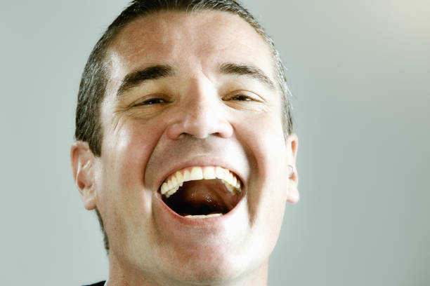 istock Handsome man's face radiates pure joy and happiness as he laughs in close-up 1306286671