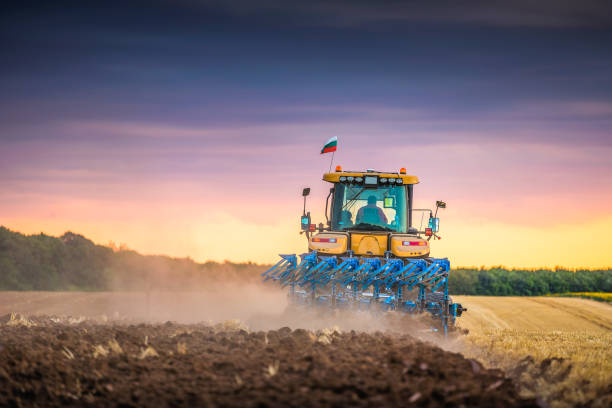 istock Tractor plowing the fields, agricultural landscape hdr 1306287893
