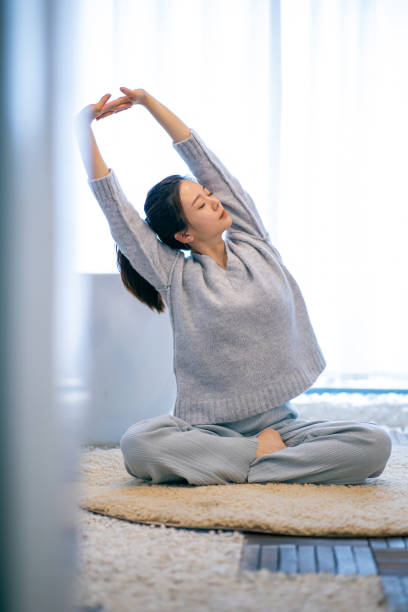 istock Young woman practicing yoga at home 1306291916