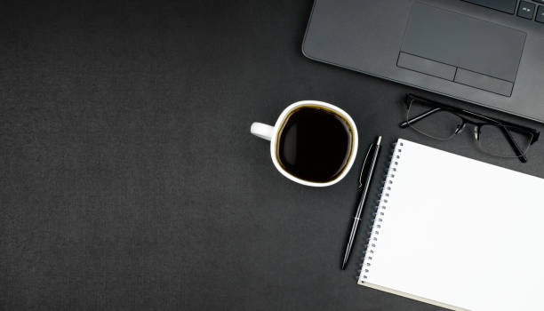 istock Business workspace with blank notepad, pen, glasses, laptop and coffee 1306291985