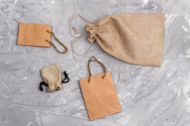 istock Kraft paper bag, eco pack, on a gray background, with place for text. 1306293210