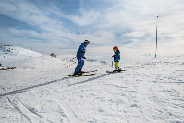 istock Boy learning how to ski on ski slope 1306293799
