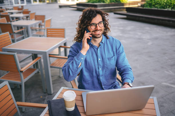 istock Handsome businessman woth curly hair using the mobile phone 1306294387