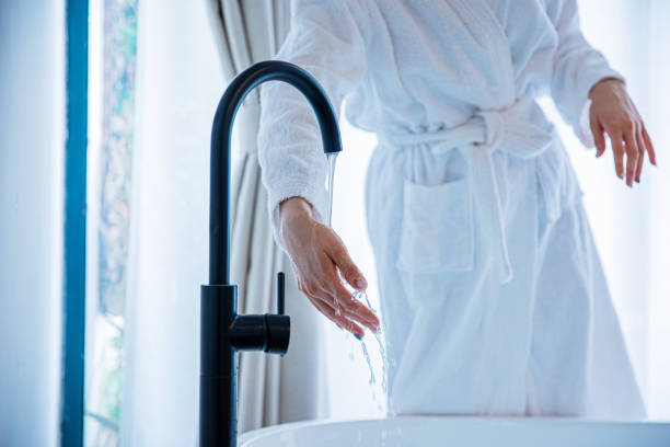 istock Young woman touching foam water before taking bath 1306295188
