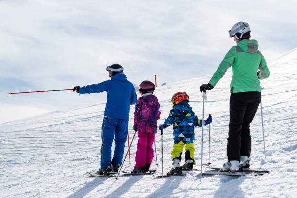 istock Ski family looking down to mountain 1306295489