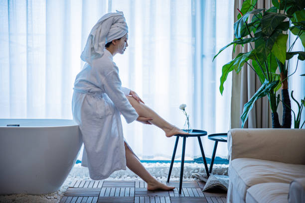 istock Woman applying moisturizer to bady after bath 1306295582