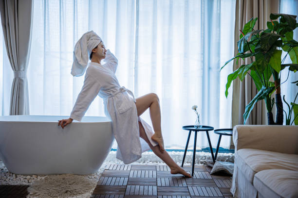 istock Young woman wearing white bathrobe in hotel 1306295654