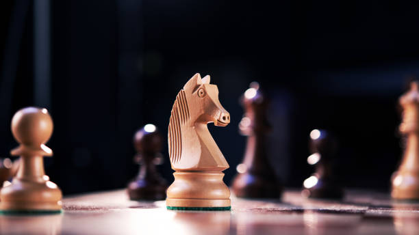 istock Wooden chess horse on a game board. 1306295836