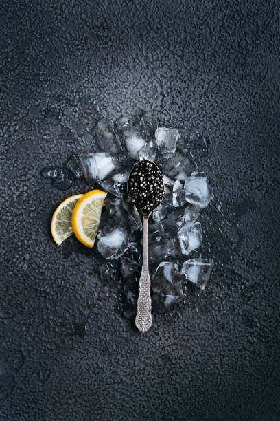 Black fish caviar on a black background. stock photo