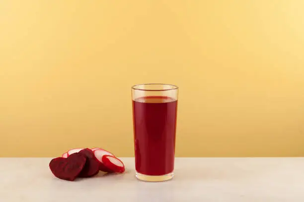 Photo of Salgam or fermented beet juice. Popular Turkish drink. Yellow background, copy space