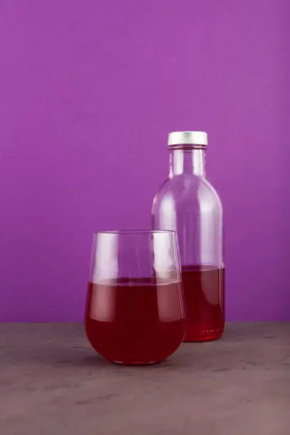 Photo of Salgam - Popular Turkish fermented drink. Traditional beverage made with water, purple carrot or turnip (juice). Selective focus, copy space