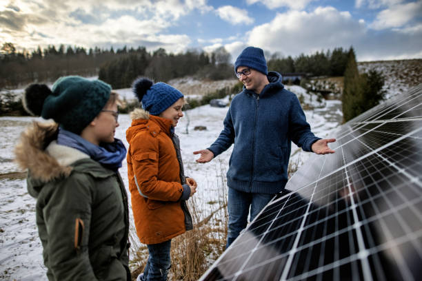 istock Mother explaining solar panels technology to the kids on a winter day. 1306300961