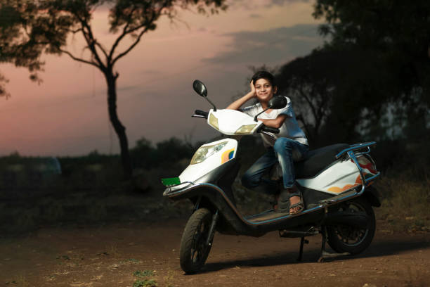 istock Cute indian little child sitting on scooter and giving multiple expression 1306301985
