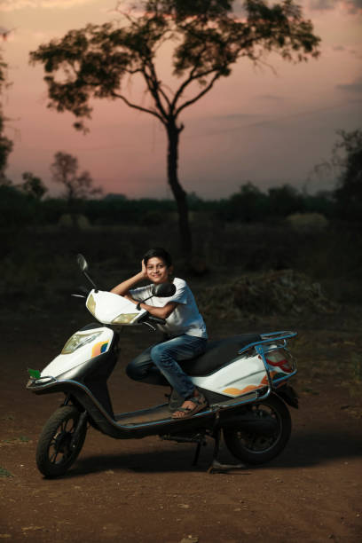 istock Cute indian little child sitting on scooter and giving multiple expression 1306302172