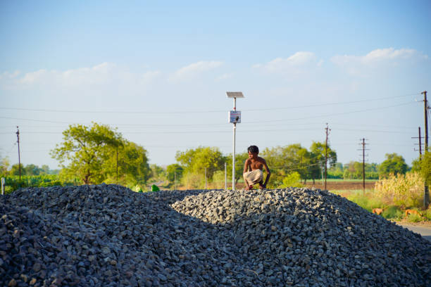istock indian poor child seating on little stone pile 1306306931