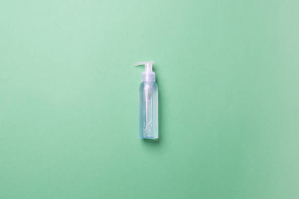 istock cosmetic bottle with liquid lying on green background 1306307029
