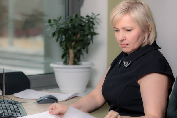 istock A female director working in an office is sitting at a table, analyzing business statistics, checking documents. 1306307417