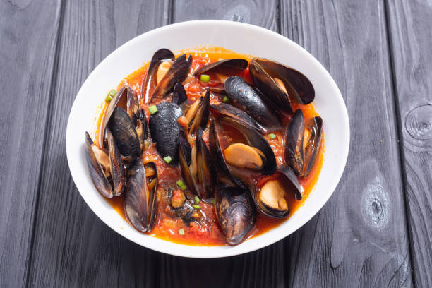 Traditional mussels tomato soup bouillabaisse. Seafood background .